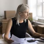 A female business owner reviewing documents in her office.