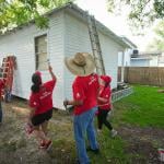 Volunteers from CITGO paint a home as part of a repairs initiative in Houston, Texas.