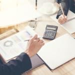 Business partners review financial documents.