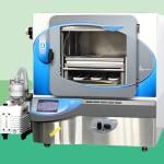 Photo of modern lab freeze dryer cut out against a stylized background of different shades of green blocks. 