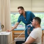 A pulmonologist checking a patient's lung functions during a spirometry test.