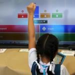 A young student celebrates a correct answer in an educational online game.