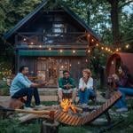 Four people sitting around a fire pit.