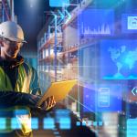 A male worker using laptop in a warehouse with an overlay of technology and logistics graphics.