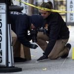 Police take photos as they place bullet casing markers outside of a Hilton Hotel in Midtown Manhattan where United Healthcare CEO Brian Thompson was fatally shot on December 04, 2024 in New York City.