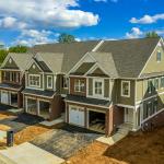 A large, modern triplex home nearing completion.