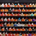 Various styles and models of Nike shoes neatly displayed on store shelves.