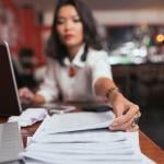 A female business owner reaches out for finance documents.