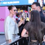 Hailey Bieber talks to guests of the Rhode x Sephora collaboration launch in New York Times Square.