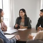 A business team seated around a conference table.