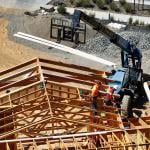 Aerial view of a home under construction with workers present on site in San Rafael, California.