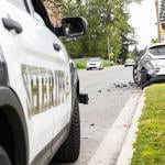 A car crash on the side of a street from the point of view of a sheriff's car.