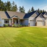 A modern, luxury home with a wide lawn in a Northwestern residential neighborhood in the US.