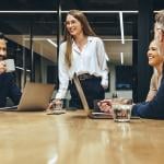 A happy business team having a meeting in a boardroom.