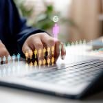 Concept of HR recruitment showing digital human figures illustrated over a businessperson using a laptop.