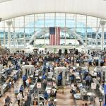 Travelers form long lines at the TSA screening areas of Denver International Airport.