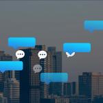 Vector chat and speech bubbles with a backdrop of city buildings.