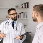 A young man consults with a physician.