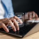 Business expense software concept using invoice graphics illustrated over a person using a laptop.