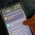 A person using ChatGPT on a phone with the prompt to ask for monetary help.