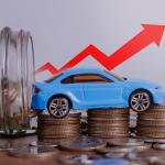 Increase price of car depicted by a small figure of a car over a stack of coins with a red upwards arrow.