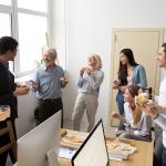 A happy business team having pizza in their office.