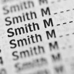 Phone book with "Smith" highlighted, representing common names.