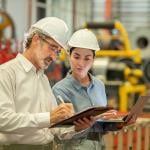Engineers in an industrial factory conducting machine inspection.