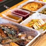 Thanksgiving dishes in catering dishes prepared on the table for serving.
