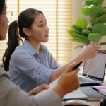 A female health care professional showing a patient x-ray results.