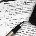 A pen and calculator on top of a credit terms report.