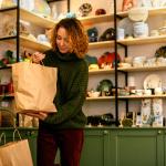 A woman packing sustainable gift items for Christmas.