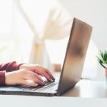Person typing on a laptop.