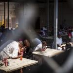 An inmate gives his daughter a hug and kiss during Father's Day at Joe Kegans State Jail's visiting hall.