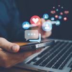 Social media interaction graphics illustrated over a person using a smartphone and laptop.