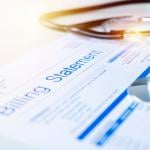 A close up on a healthcare billing statement document with a stethoscope on top.
