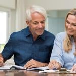 A man and a woman looking at financial documents.