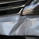 A car's bumper dented from a hit.