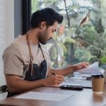 A small restaurant business owner working on tax documents.