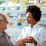 A female pharmacist helping senior customers.
