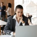 A young female professional working in a corporate office.