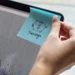 A person sticking a savings note on a computer screen.