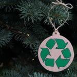 A recycling symbol ornament on a Christmas tree.