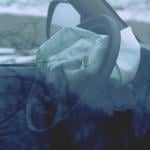 A car's steering wheel with a deployed airbag.