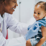 A pediatrician giving a toddler a vaccination.