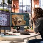 A professional interior designer using two monitors to work on a project.