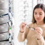 A young woman checking eyeglasses options.