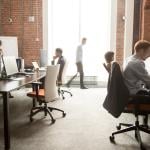 A busy team of employees around a modern office.