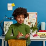 A young woman writing down plans in her notepad.