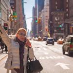 Woman signaling for a cab in New York City. 